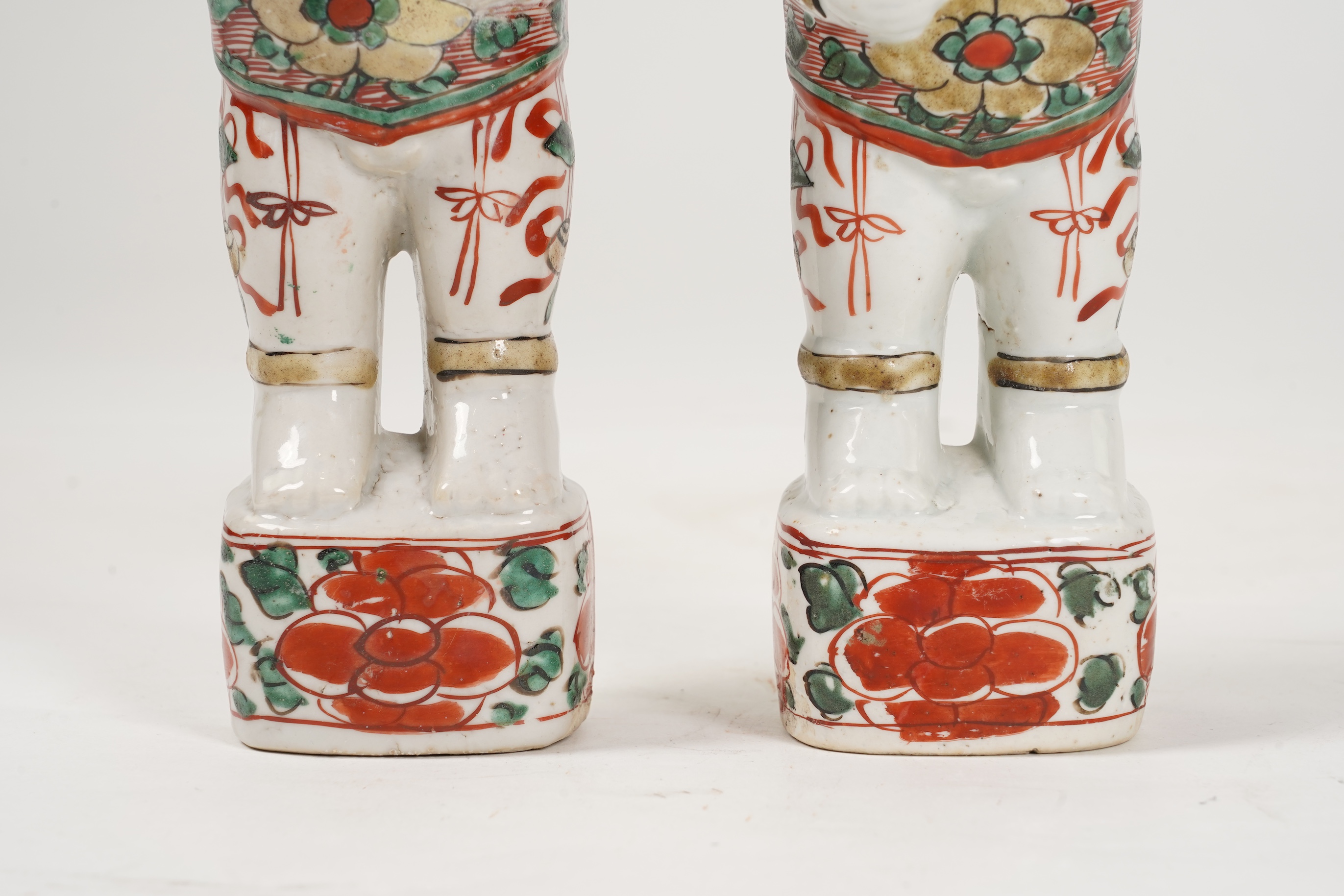 A pair of Chinese famille verte figures of smiling boys, Kangxi period